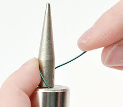 Wire being anchored on mandrel